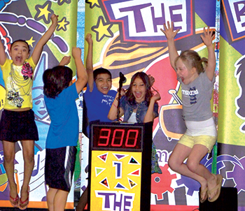 Students jumping in excitement as they win points in The Brain Show